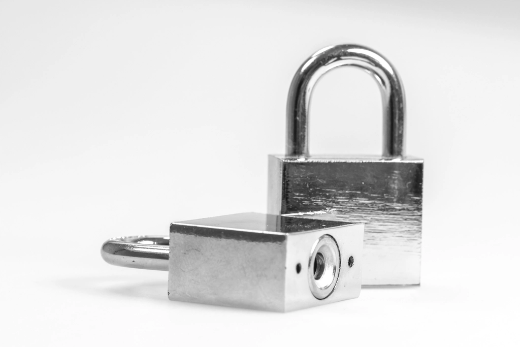 Two silver padlocks representing file cabinet lock security